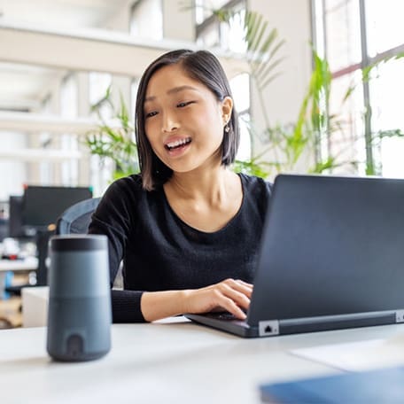 Diverse office colleagues laughing together during a meeting